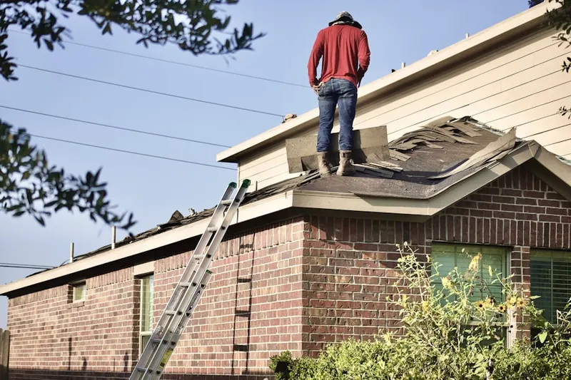 Professional roofer working on a residential roof in Mantoloking Estates